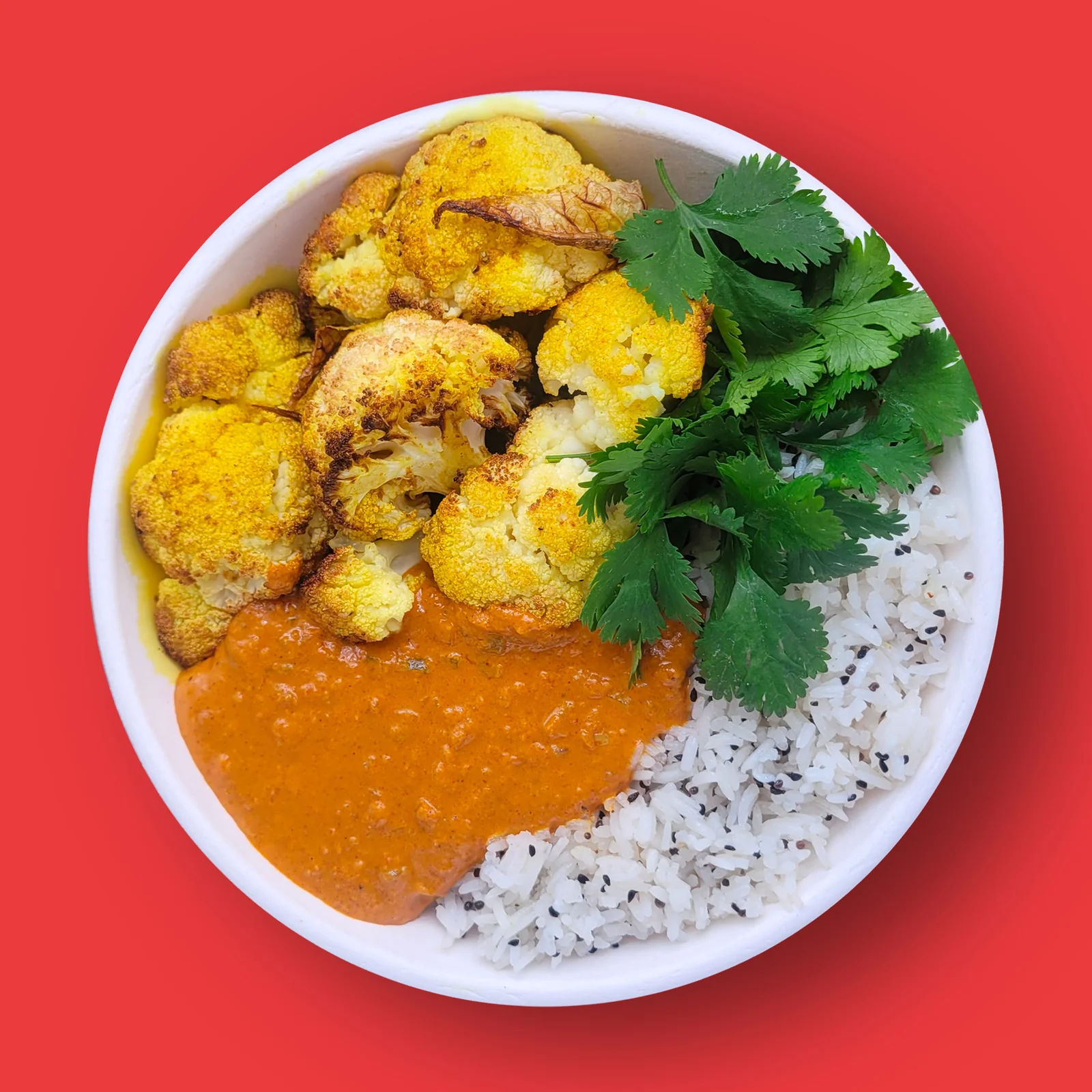 Cauliflower Tikka Masala: Turmeric roasted cauliflower in a rich sauce of tomato, coconut milk and toasted spices with cardamom rice