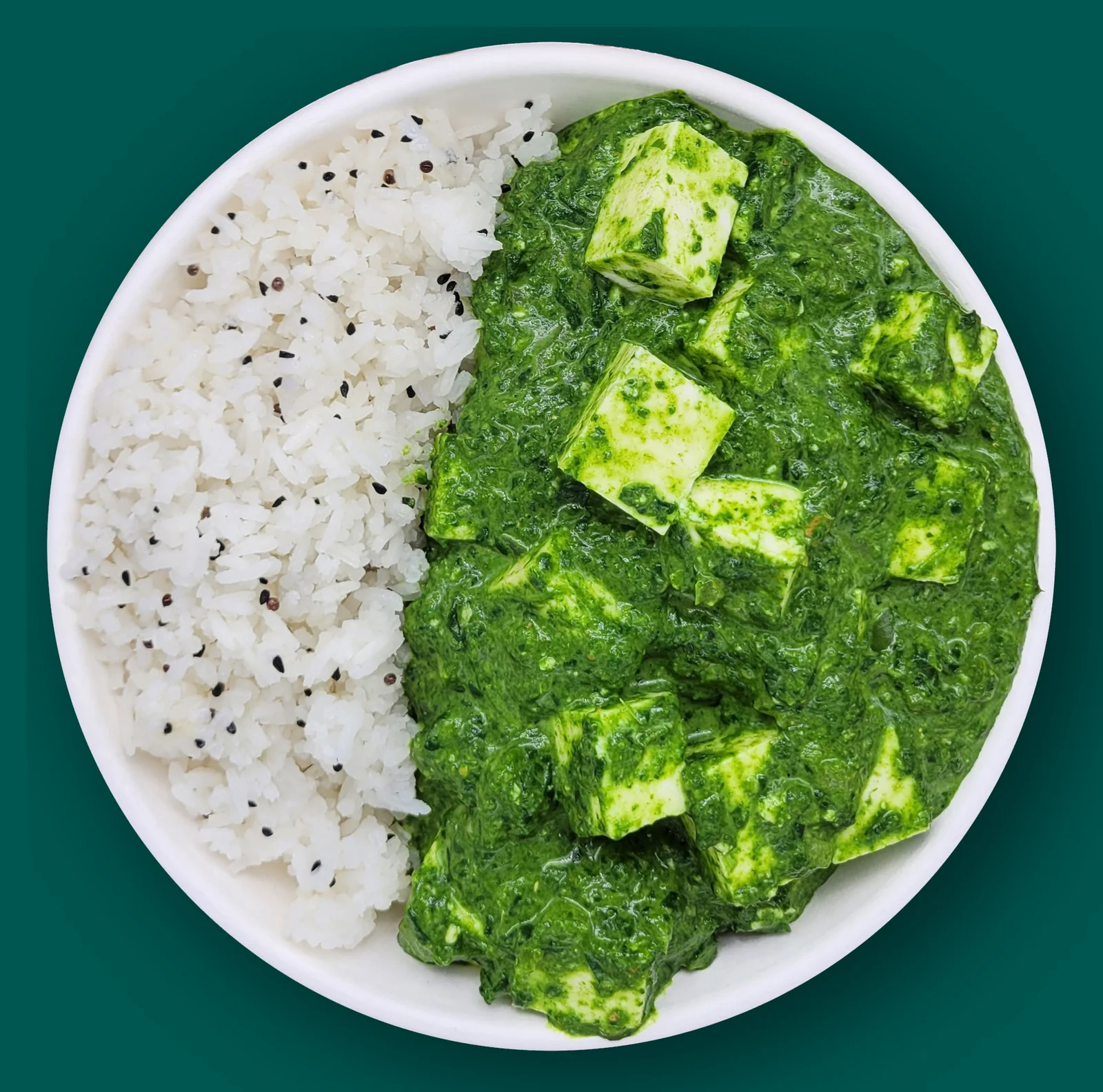 Saag Paneer: Cubes of paneer cheese in a creamy spinach sauce with ginger, garlic, fresh chiles and spices with cardamom rice