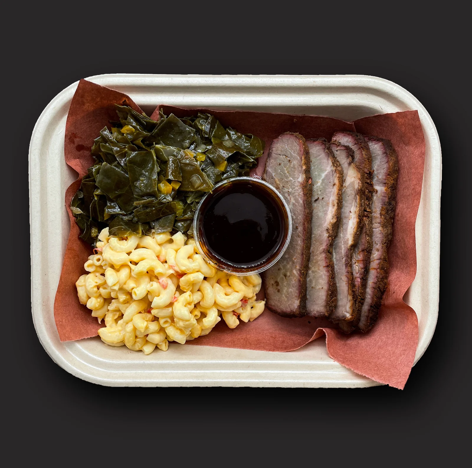 Smoked Beef Brisket: Smoked beef brisket, Black Bark BBQ sauce, mac & cheese, collard greens 